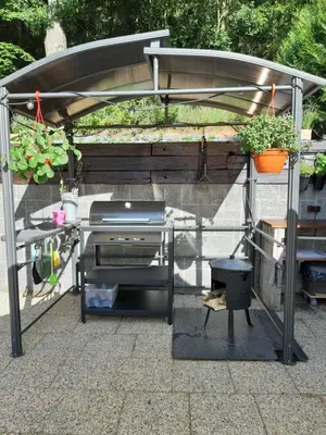 a barbecue grill under a cover on a patio at Cottage Nova in Živohošť