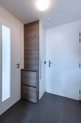 a room with a wooden door and a hallway at Spacious Top Floor Flat, Air Conditioning, Free Parking, 200Mb WiFi in Prague