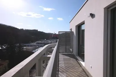 a balcony of a building with a view of a city at Spacious Top Floor Flat, Air Conditioning, Free Parking, 200Mb WiFi in Prague