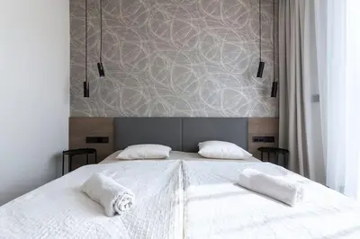 a bedroom with a large white bed with two pillows at Spacious Top Floor Flat, Air Conditioning, Free Parking, 200Mb WiFi in Prague