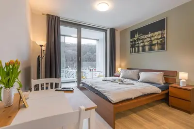 a bedroom with a bed and a large window at On-site Free Parking, 12 to min Centre, Supermarket in Prague