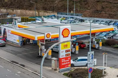 a gas station with cars parked in a parking lot at On-site Free Parking, 12 to min Centre, Supermarket in Prague