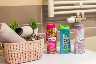 a bathroom counter with some cleaning products and a basket at On-site Free Parking, 12 to min Centre, Supermarket in Prague