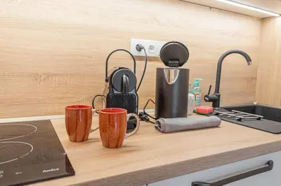 a kitchen counter with two cups and a blender at On-site Free Parking, 12 to min Centre, Supermarket in Prague