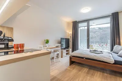 a bedroom with a bed and a large window at On-site Free Parking, 12 to min Centre, Supermarket in Prague