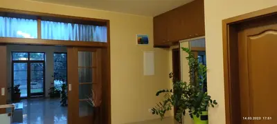 a house with a balcony and flowers in the yard at Villa Homestay Nad Helmrovkou in Prague
