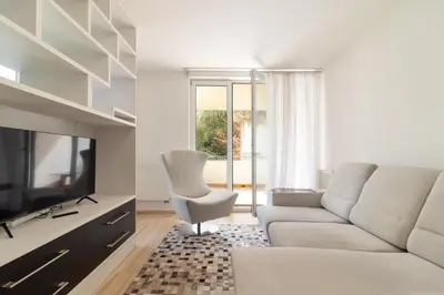 a living room with a couch and a television at Peace and Comfort Near Center with Balcony, 500MB WIFI in Prague