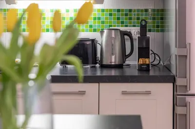 a kitchen counter with a coffee maker and a toaster at Peace and Comfort Near Center with Balcony, 500MB WIFI in Prague