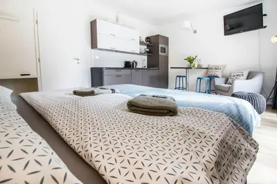a bedroom with two beds with towels on top of it at Stylish Studio with Balcony, 12 Min to City Centre, Free Netflix & WiFi in Prague