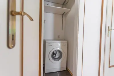 a washer and dryer in a small laundry room at Josef Manes birth house, All Sights Walkable, Old Town Square in Prague