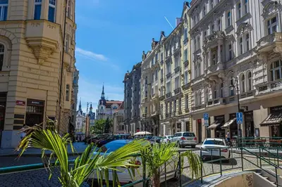 a city street with buildings and plants on the street at Josef Manes birth house, All Sights Walkable, Old Town Square in Prague