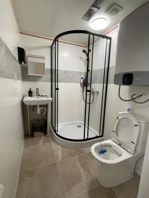a bathroom with a shower and a toilet and a sink at Trung Lo Cao in Prague