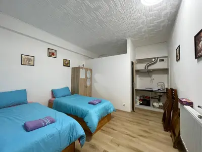 two beds in a room with blue sheets at Trung Lo Cao in Prague
