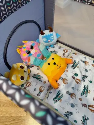 a group of stuffed animals sitting on a bed at ESMOA apartments - Ovenecká, Praha 7 - plně vybaven in Prague