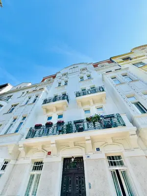 a tall white building with balconies and a door at ESMOA apartments - Ovenecká, Praha 7 - plně vybaven in Prague