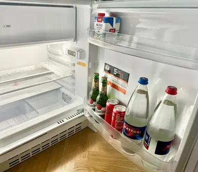 an open refrigerator filled with drinks and sodas at ESMOA apartments - Ovenecká, Praha 7 - plně vybaven in Prague