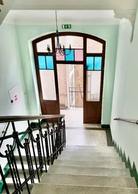 a hallway with a staircase with a door and a window at ESMOA apartments - Ovenecká, Praha 7 - plně vybaven in Prague