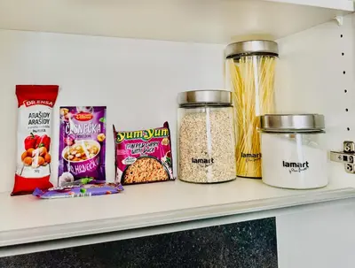 a shelf with cereals and other food items at ESMOA apartments - Ovenecká, Praha 7 - plně vybaven in Prague