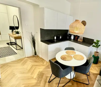 a kitchen with a table and chairs in a room at ESMOA apartments - Ovenecká, Praha 7 - plně vybaven in Prague