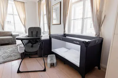 a black bunk bed in a room with a chair at Royal Residence Vysehrad Prague in Prague