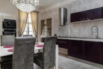 a kitchen with a table and a dining room at Royal Residence Vysehrad Prague in Prague