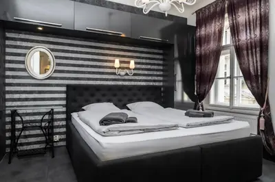 a bedroom with a bed with a black and white striped wall at Royal Residence Vysehrad Prague in Prague
