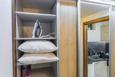 a stack of pillows on a shelf in a kitchen at Flat with Bathtub & Balcony, only 12min Centrum, 200Mb WIFI in Prague