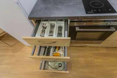 a kitchen with a counter with a drawer with utensils at Flat with Bathtub & Balcony, only 12min Centrum, 200Mb WIFI in Prague