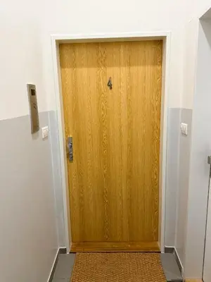 a wooden door in a room with a hallway at Vantisch Old Town Apartment in Prague