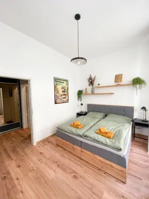 a bedroom with a bed in the middle of a room at Vantisch Old Town Apartment in Prague