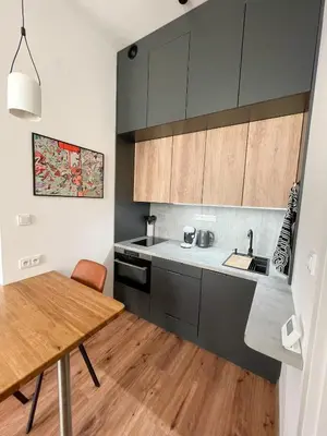 a kitchen with a wooden table and a wooden floor at Vantisch Old Town Apartment in Prague