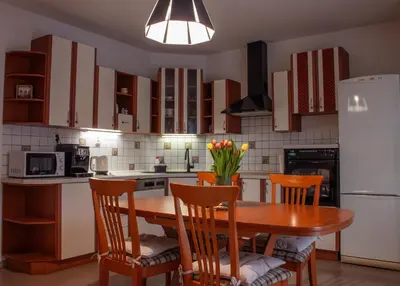 a living room with a wooden table and chairs at Apartmán se společným bazénem Zlonice in Zlonice