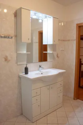 a bedroom with a bed and a tv on the wall at Apartmán se společným bazénem Zlonice in Zlonice