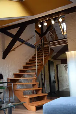 a spiral staircase in a building with wooden steps at Đã Về - Đã Tới in Prague
