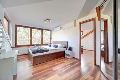 a large bedroom with a bed and a mirror at Đã Về - Đã Tới in Prague
