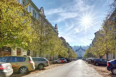 a street with cars parked on the side of the road at Đã Về - Đã Tới in Prague