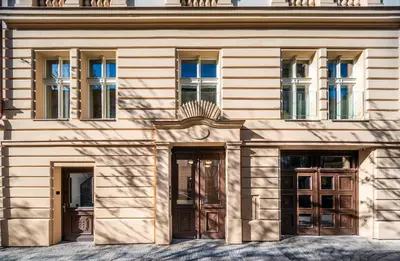 a large building with doors and windows on it at Accordion Boutique Hotel & Premium Suites in Prague