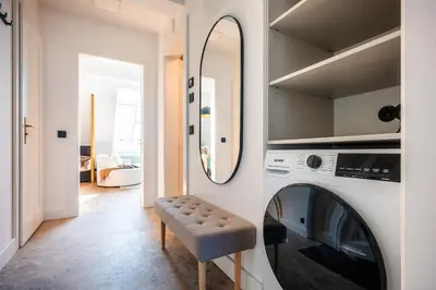 a laundry room with a washing machine and a mirror at Accordion Boutique Hotel & Premium Suites in Prague