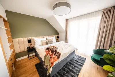 a bedroom with a bed and a large window at Accordion Boutique Hotel & Premium Suites in Prague