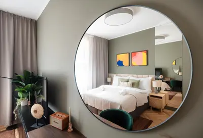 a bedroom with a bed and a mirror at Accordion Boutique Hotel & Premium Suites in Prague