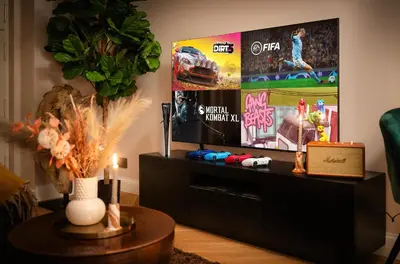 a living room with a flat screen tv on a tv stand at Accordion Boutique Hotel & Premium Suites in Prague