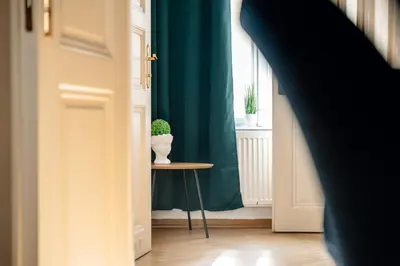 a door with a plant on a table next to a window at Wagnerstays Royal Billiard Residence in Prague