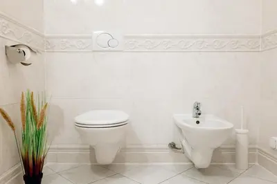 a white bathroom with a toilet and a sink at Wagnerstays Royal Billiard Residence in Prague