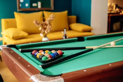 a pool table with a cue and balls on it at Wagnerstays Royal Billiard Residence in Prague