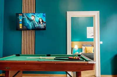 a room with a pool table and a flat screen tv at Wagnerstays Royal Billiard Residence in Prague