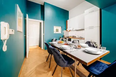 a dining room with blue walls and a table and chairs at Wagnerstays Royal Billiard Residence in Prague