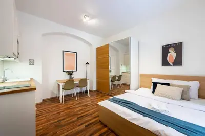 a bedroom with a bed and a desk and a table at Adorable Cozy Studio in Central Prague in Prague