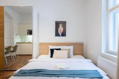 a bedroom with a bed with a blue blanket on it at Adorable Cozy Studio in Central Prague in Prague