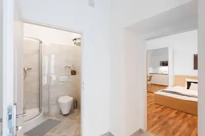 a bathroom with a shower and a bed in a room at Adorable Cozy Studio in Central Prague in Prague