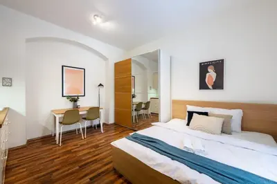 a bedroom with a bed and a desk in it at Adorable Cozy Studio in Central Prague in Prague